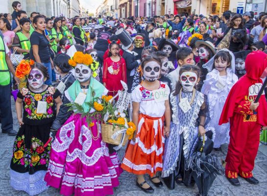 Mexican children made up as skeletons, at a street festival, for the day of the dead.