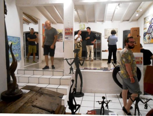 People observing paintings and sculptures in an art gallery in Puerto Vallarta Mexico.