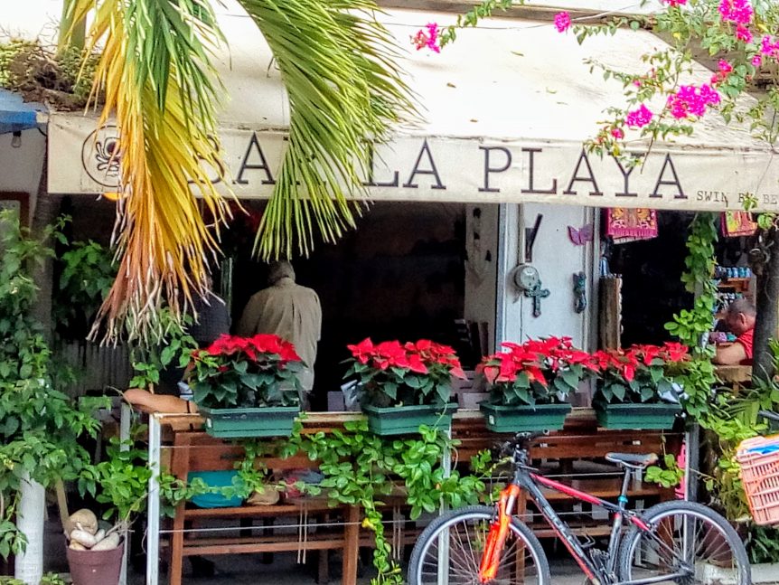 entrance to bar la playa with tables and chairs outside