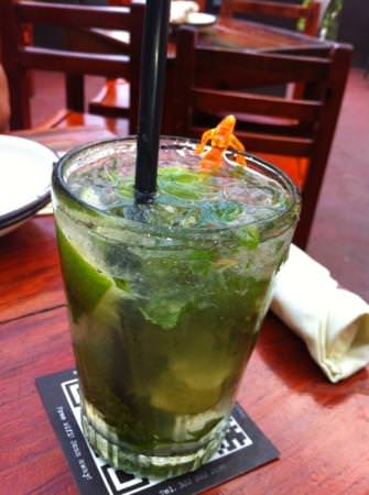 a glass filled with joe jacks famous mojito. 