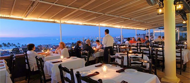 patrons at a table in restaurant barcelona tapas in Puerto Vallarta