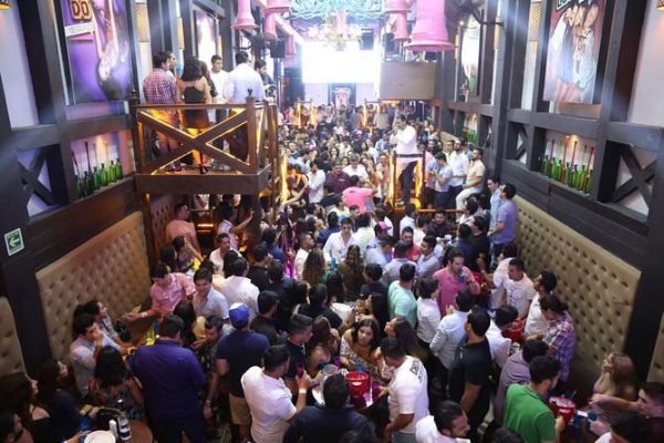 Patrons gather around tables in the disco bar Vaqiuta in Puerto Vallarta 