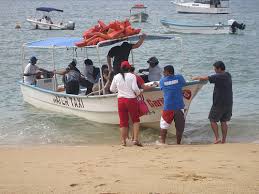 a water taxi loading people from the beach in Boca de Tomatlan