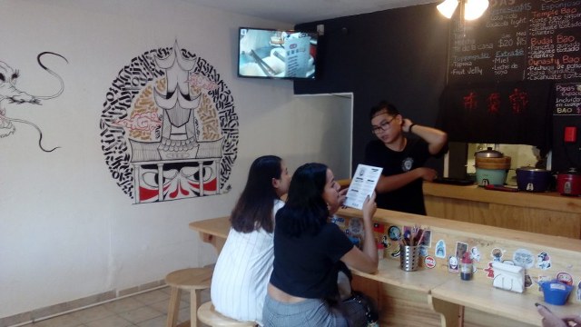 two customers sit at the counter in restaurant Budaix in Puerto Vallarta