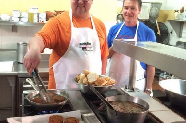 Two students working in the kitchen of the restaurant el Arrayan, while taking a cooking class in Puerto Vallarta.