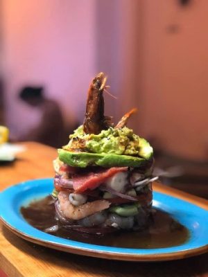 mixed seafood stacked on a tostada