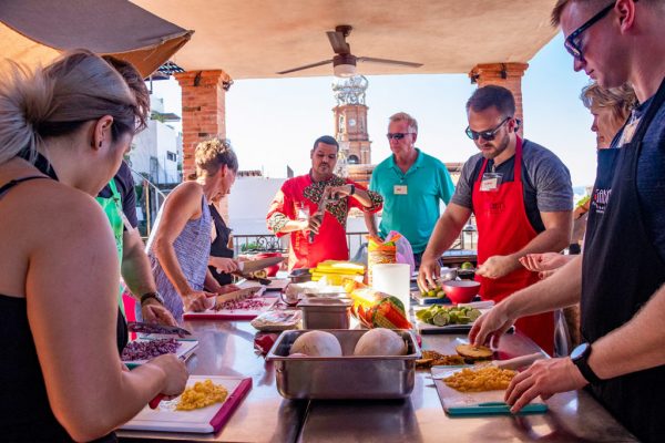 Chef Julio Castellon instructs his students around a table in a cooking glass at Gaby's in Puerto Vallarta.