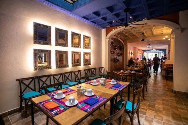 A table set with colorful placemats in restaurant Poblanos Cocina Mexicana in Puerto Vallarta.