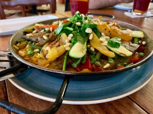 seafood and vegetables in a bowl o a blue plate