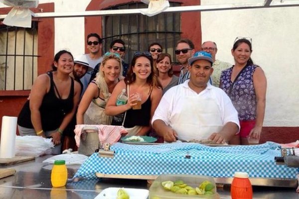 Vallarta Food Tours group of people gather around a taco stand in Puerto Vallarta Mexico