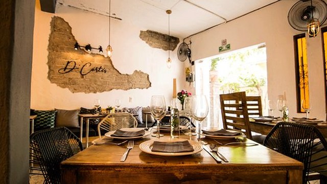 table, set with plates, and glasses in the dining room of d'Cortes in Puerto Vallarta