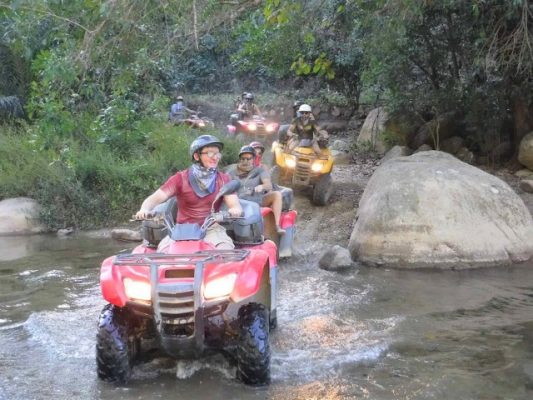 ATV  tour crossing a river in Puerto Vallarta Mexico