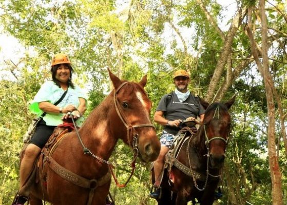 a woman and man on horses in the jungle of Puerto Vallarta Mexico