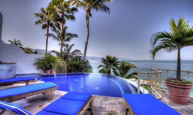 a private swimming pool and palm trees and views of the bay of banderas